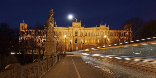  The Maximilianeum seat of the Bavarian State Legislature at night with light trails created by a passing streetcar