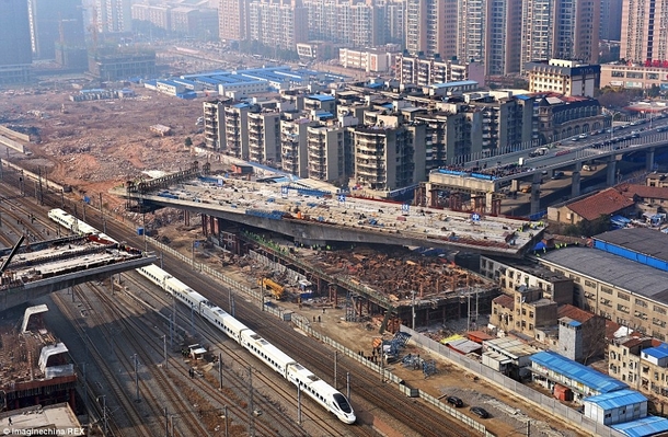  ton bridge section built next to train tracks and slowly rotating into place - Wuhan City China 