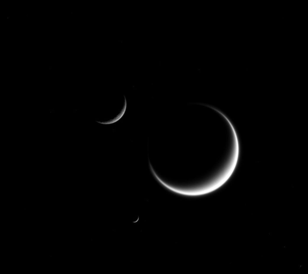 A beautiful shot of Saturns moon Titan Rhea and Mimas taken by Cassini spacecraft back in 