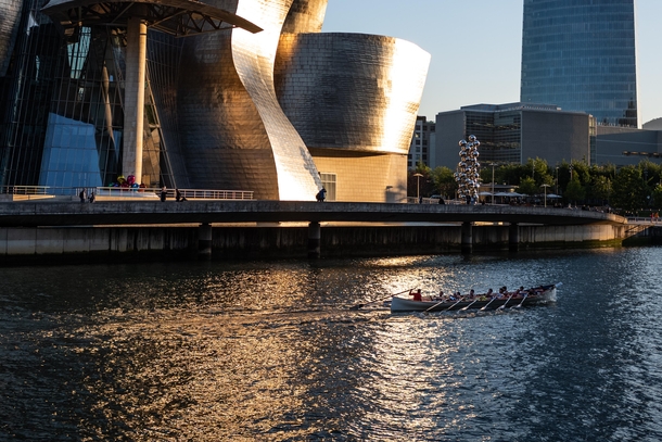 A boat floating past Gehrys Guggenheim Museum in Bilbao Spain 