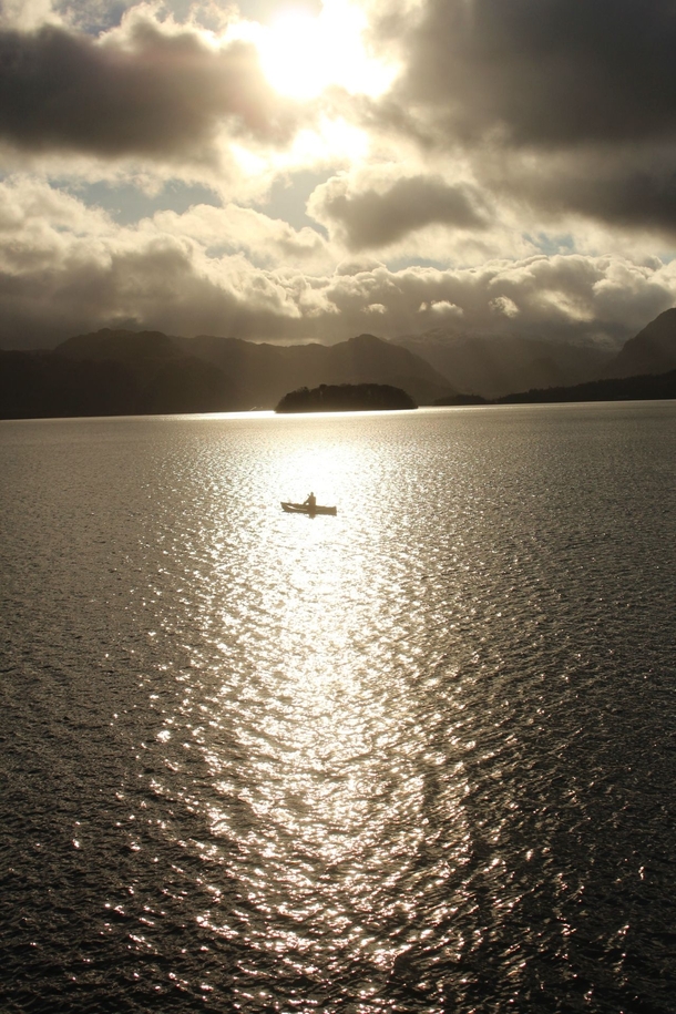 A canoeist in the sunlight at Derwent Water The Lake District 