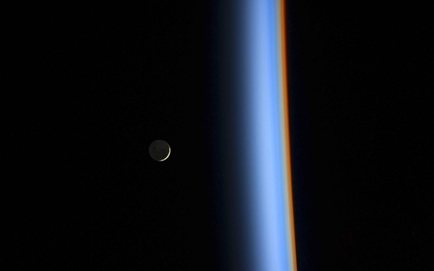 A crescent moon and the earths atmosphere taken from the ISS Feb st  