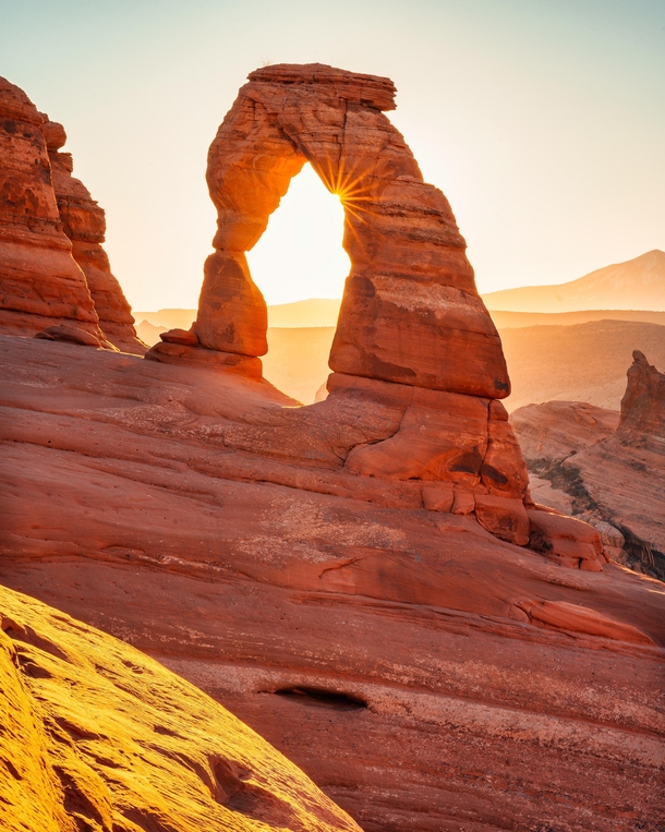 A delicate formation of red rocks at sunrise Arches National Park Moab Utah OC x