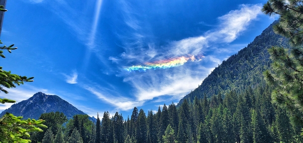 A fiery feather of a rainbow in the clouds over Wallowa Lake in Oregon  x