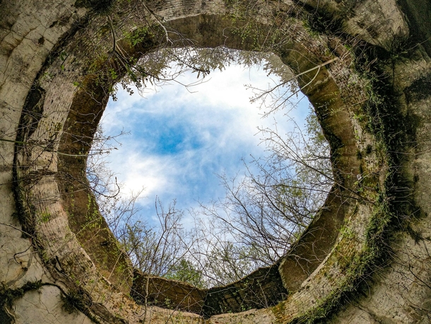 A hole in the roof of an overgrown th century fortress 