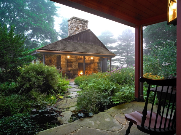 A Magical RefugeRustic outdoor fireplace beckons across a lush drizzly Courtyard - Restored  Abiah Taylor House  West Chester PA John Milner Architects 