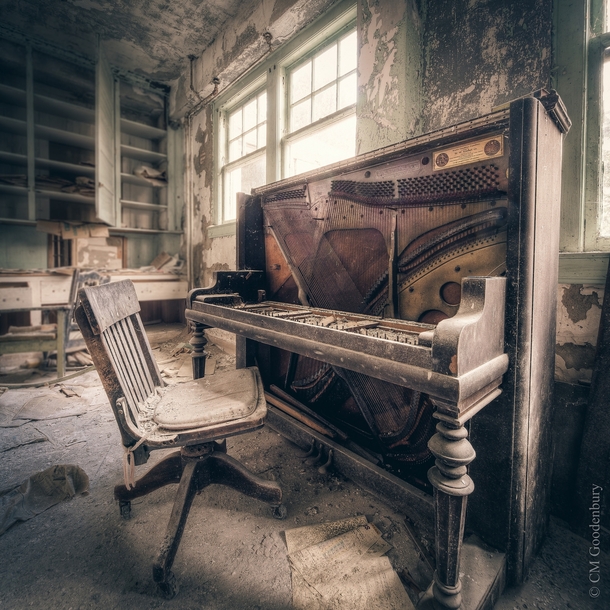 A partially stripped piano in an abandoned asylum 