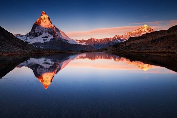 A perfect sunrise on the Matterhorn reflected in the mirror-like Riffelsee  photo by Sven Mller from rSchweiz