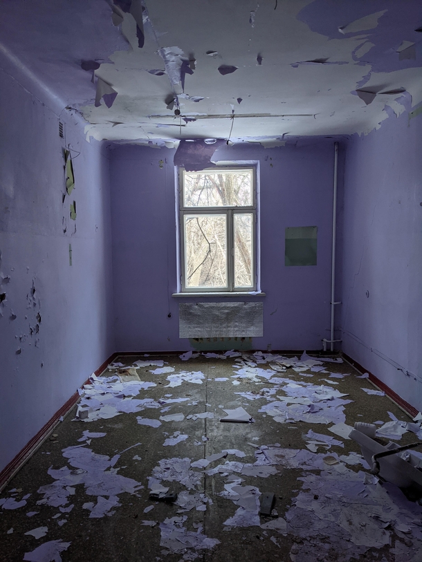A purple room in an abandoned psychiatrist hospital for adolescents 