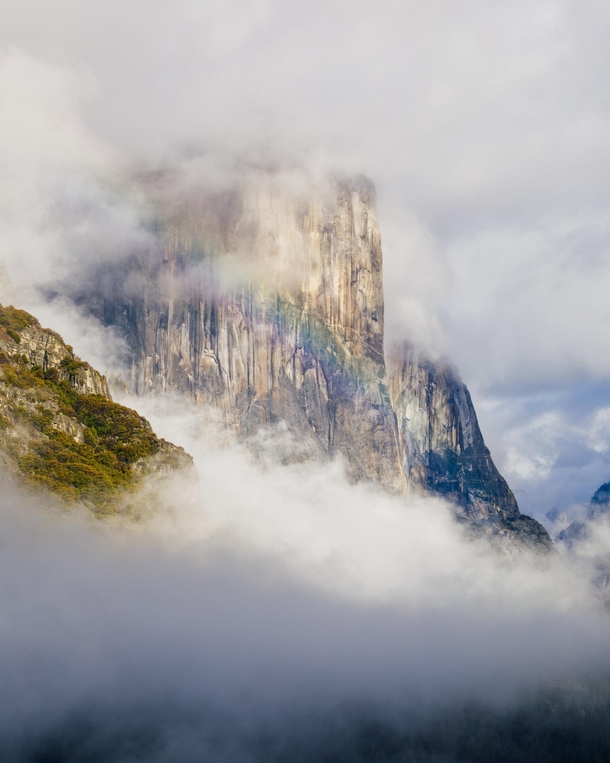 A rainbow forming in front of El Capitan after a rainy morning - Yosemite National Park CA 