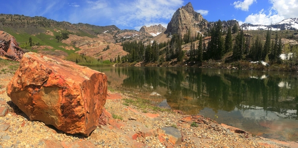 A red rock sits in front of Lake Blanche UT 