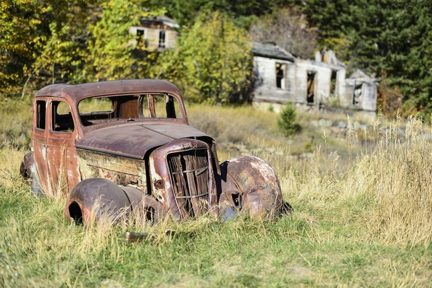 A rusty old car sits along Main Street in Marysville Montana 
