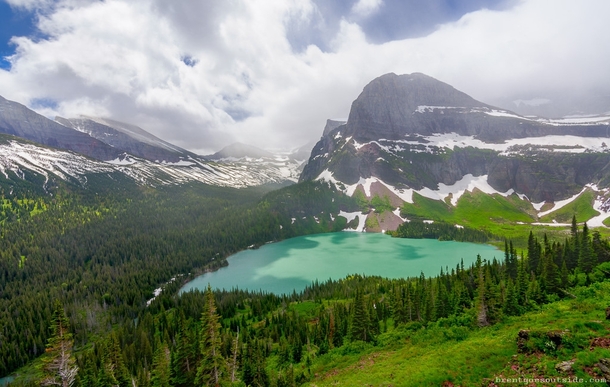 A teal lake and stunning mountain in Glacier National Park Montana 