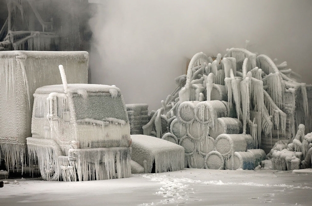 A truck is covered in ice as firefighters work to extinguish a massive blaze at a vacant warehouse in Chicago Illinois on January   More than  firefighters battled the five-alarm fire as temperatures were in the single digits 