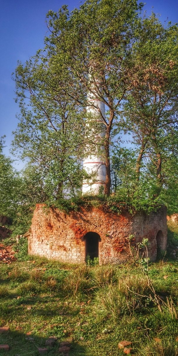 Abandoned brick furnace near a fully constructed abandoned brick furnace with  meter tower