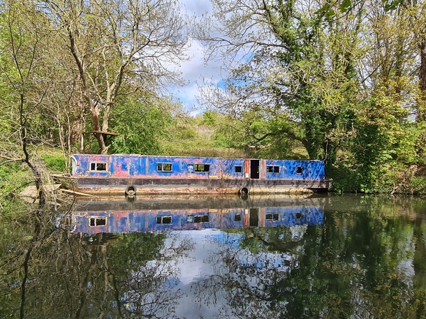 Abandoned canal boat along the Grand Union Canal