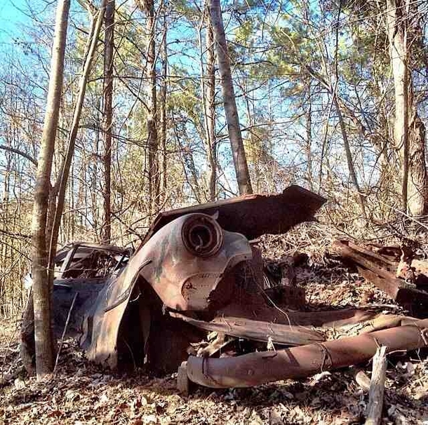 Abandoned car left in the middle of the woods 