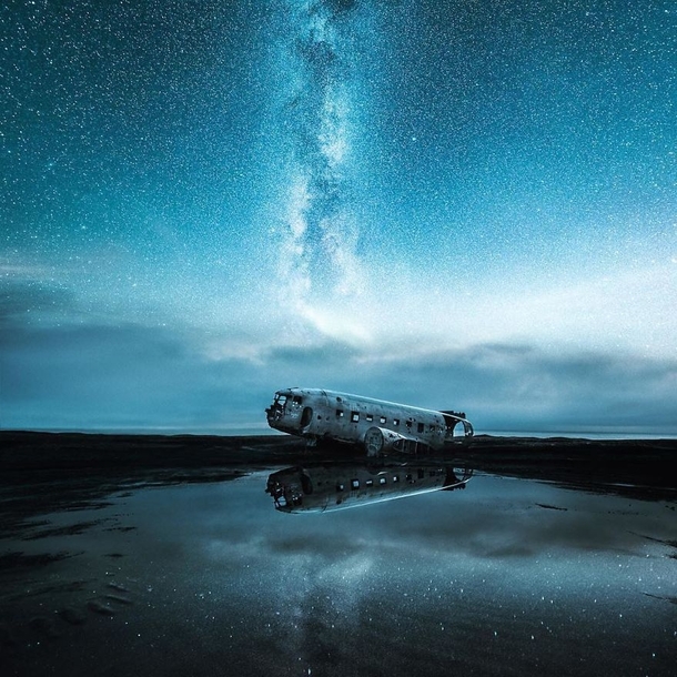 Abandoned Debris of a plane underneath a starry sky 