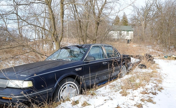 Abandoned house and Oldsmobile in rural Wisconsin