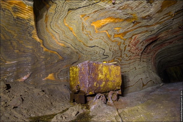Abandoned Mining cart on the bottom of the ancient sea Endless mining shafts of beautiful colorful patterns of minerals Photo by Mishainik Russia 