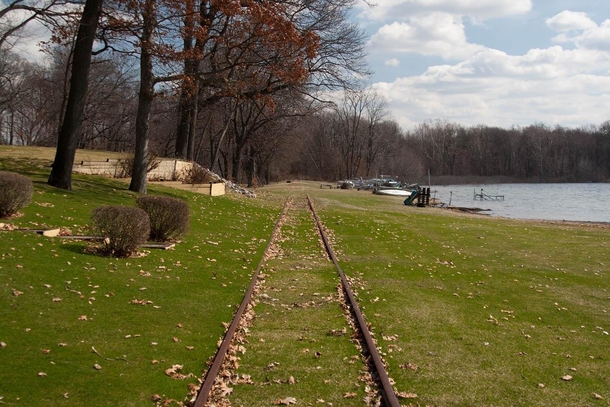 Abandoned railroad tracks nearly embedded into the ground Torn up a few years ago