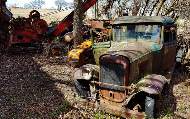 Abandoned vintage truck among other rusty friends on a farm in rural Franklin GroveIL By Bill 