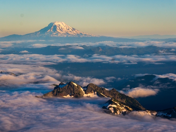 Above the clouds on Mount Rainier with Mount Adams in the background 