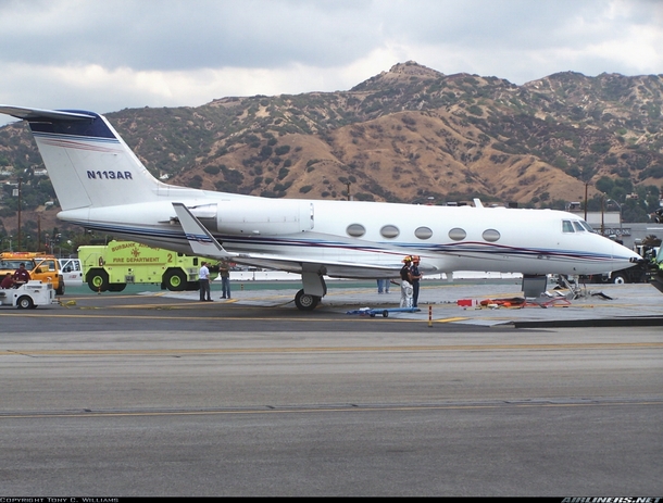 After overrunning Runway  at Burbank Airport a Gulfstream II jet is stopped from crashing through a fence and onto a busy roadway by an EMAS Engineered Materials Arrestor System a crushable concrete pad which traps the landing gear and stops the speeding 