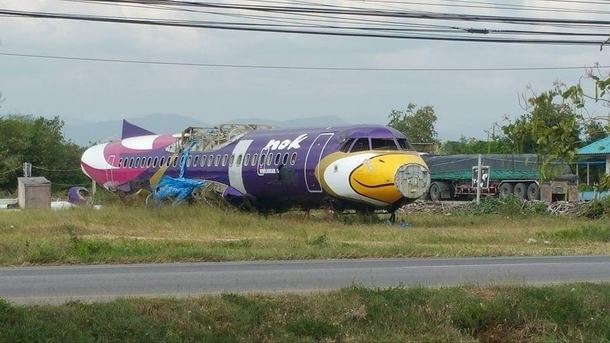 An abandoned and parted out plane on the side of the highway in Thailand for some strange reason