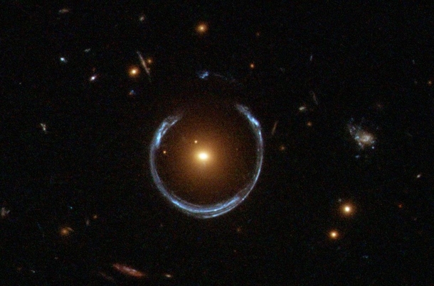 An Einstein Ringor gravitational lensing at work the blue galaxy is behind the yellow galaxy but we can see it because the light from the far galaxy gets wrapped around by the closer galaxy  Photo NASAHubble