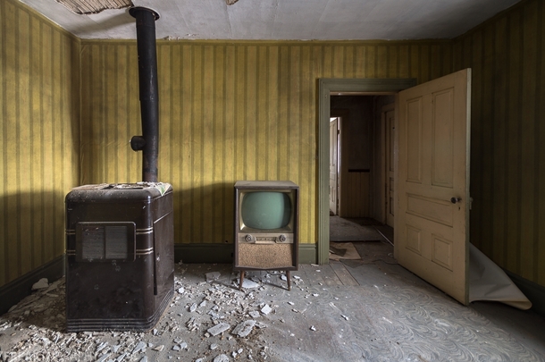 An old television next to an old furnace in an abandoned house in northeastern Ontario Canada OC   