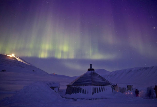 Arctic hut on the island of Spitsbergen lit by Aurora 