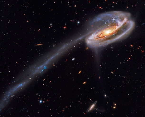 Arp  and the Tadpoles Tail  Its eye-catching tail is about  light-years long -- more than  times the diameter of the Milky Way -- and features massive bright blue star clusters The tail was created because another galaxy passed near it 