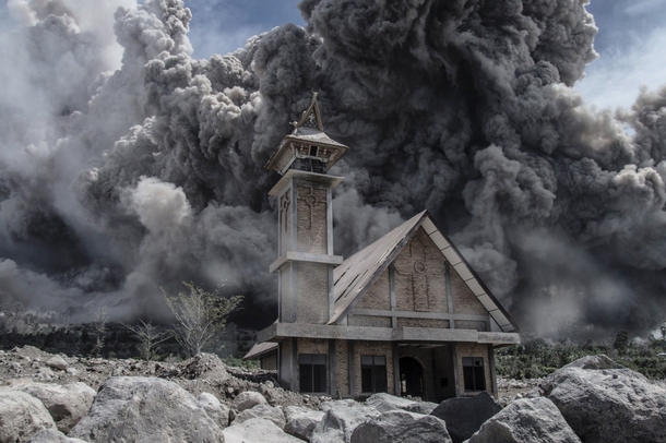 Ash from Mount Sinabung volcano fills the sky over an abandoned church during another eruption in Karo North Sumatra Indonesia  Photo by Sutanta Aditya