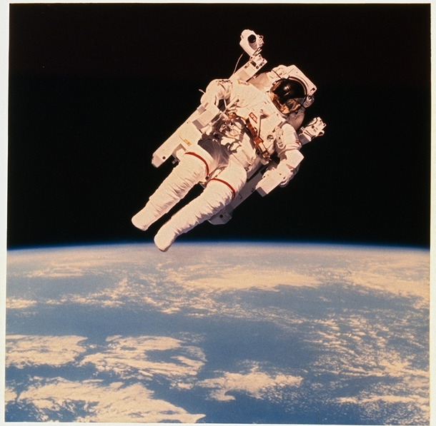 Astronaut Bruce McCandless II floats a few meters away from Space Shuttle Challenger during the historic first use of a nitrogen-propelled manned maneuvering unit in  NASA 
