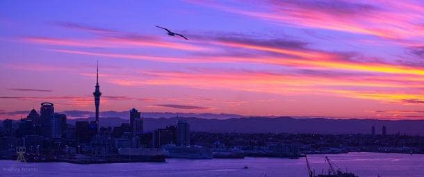Auckland skyline at sunset with the Waitakere ranges in the background