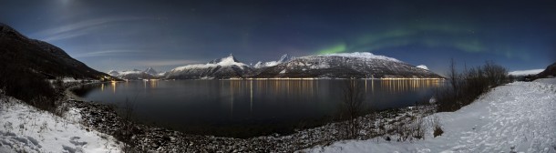 Aurora borealis above Storfjorden and the Lyngen Alps in moonlight 