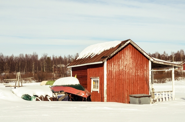 Boathouse by the frozen lake Muonio Finish Lapland 