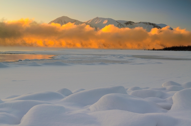 British Columbia Canada This large fog bank was traveling down the length of Atlin Lake It was mostly in the shade until the warm rays of a setting sun hit it from behind It felt like someone had just tripped a light switch writes photographer Christian B