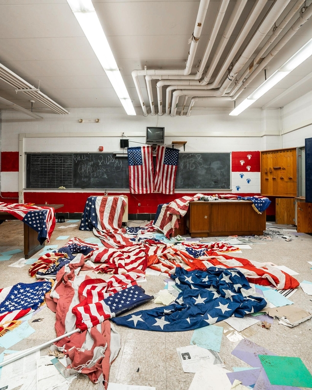 Came across dozens of American flags scattered all over the floor inside this abandoned inner city high school 