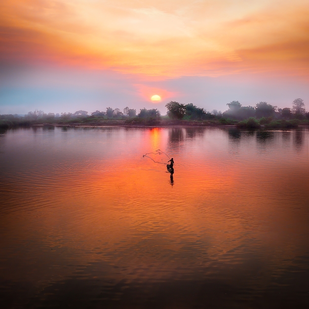 Casting his net at sunset in Laos Photo credit to Simon Matzinger 