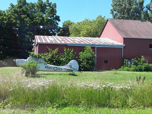 Cessna A with its wings detached near a barn C-FJPA Chatham-Kent ON