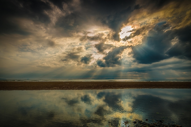 Clearing clouds and reflection after a mid-summer storm from an Ayrshire beach Scotland 