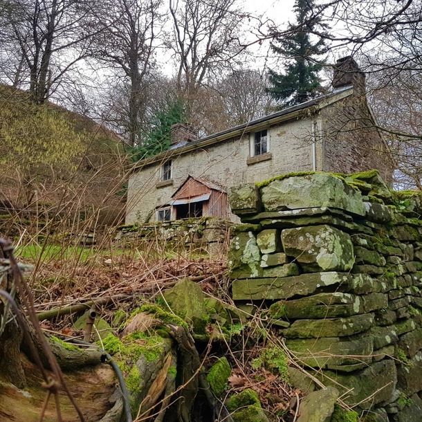 Cottage nestled against hill 