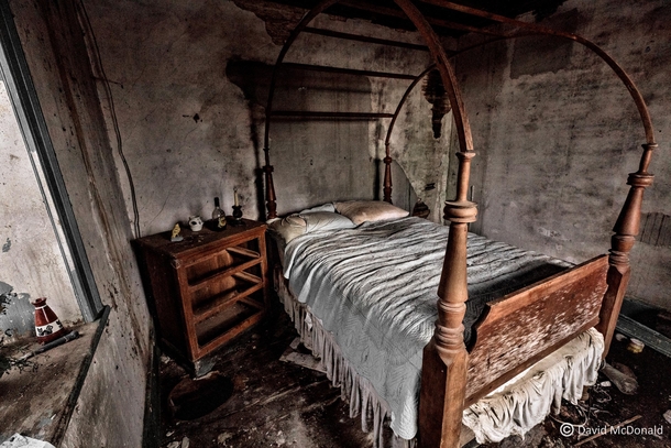 Cross post suggested A shot of a young girls bedroom in an abandoned stone house with the bed still made 