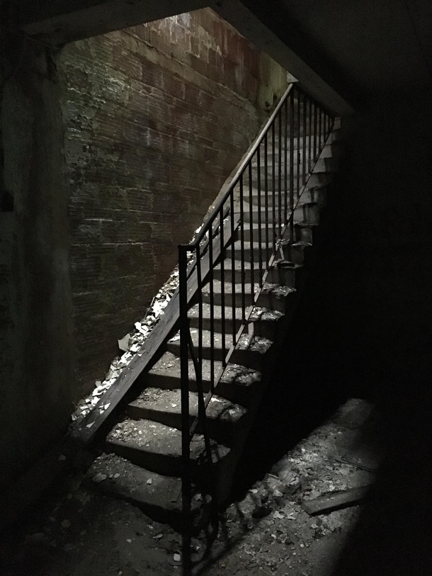 Crumbling staircase in the basement of a derelict insane asylum in Maryland 