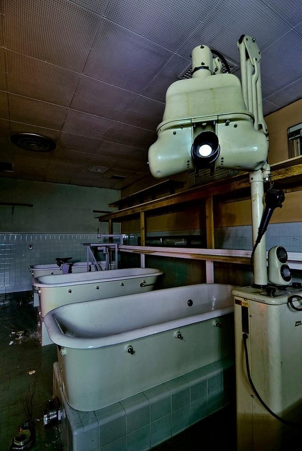 Dental X ray machine and old hydro-therapy tubs in a basement at Agnews Hospital Oddly enough there is also a bicycle powered band saw in the background OC x
