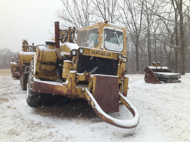 Derelict construction equipment during a snowstorm in Saint Albans MO 