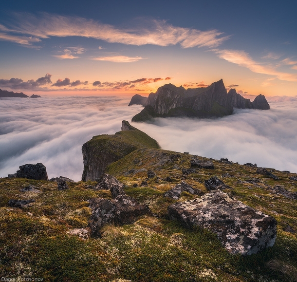 Dragons ridge - the mountains of Senja Norway piercing through the clouds  by Daniel Kordan