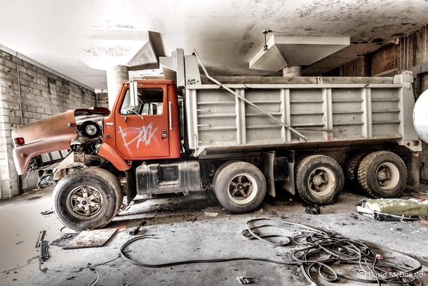 Dump truck left to rust in a heavy machinery garage after a fire decimated the upper floors